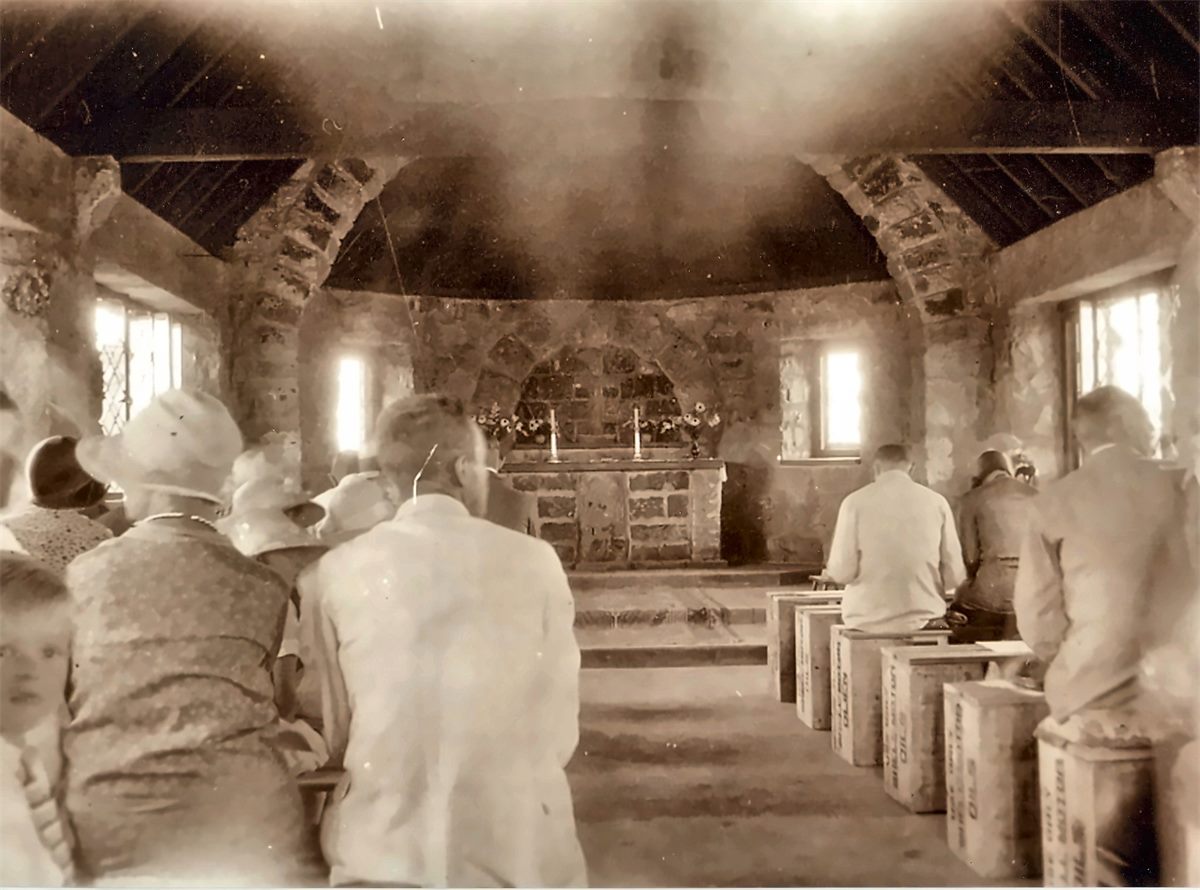 The founding congregation at worship in the 1930s, seated on pews made from paraffin boxes