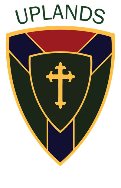 The Uplands School crest, showing the branching Y and the cross at its centre